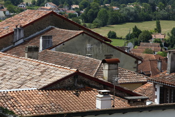 Fototapeta na wymiar roofs with chimneys of small town