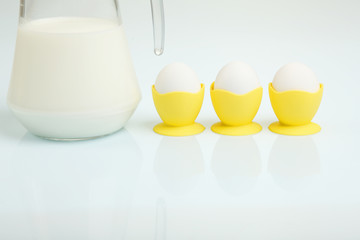 Milk in a glass jar and eggs