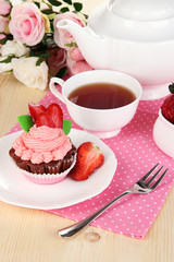 Beautiful strawberry cupcake and flavored tea