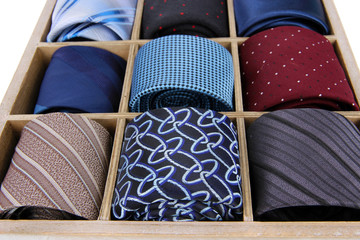 Neckties in wooden box close-up