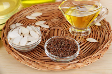 Useful linseed oil and pumpkin seed oil on wooden table