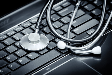 Stethoscope lying down on an laptop