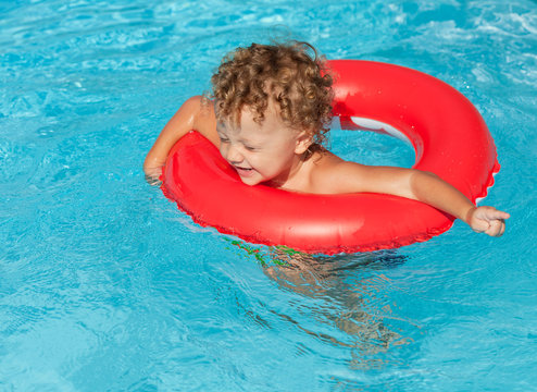little boy in the swimming pool  with rubber ring