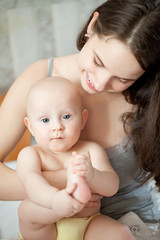 happy-looking baby and mother playing together