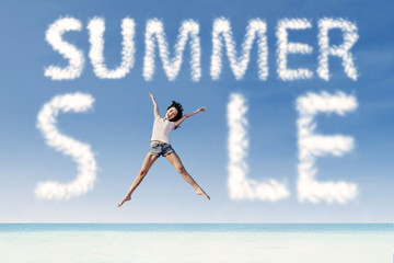 Summer sale clouds and woman jumping at beach