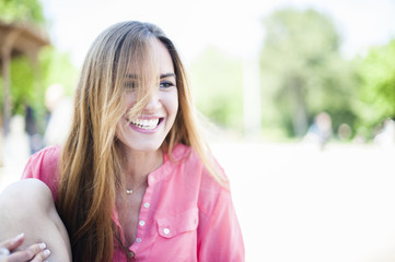 Young smiling woman in a park during spring season
