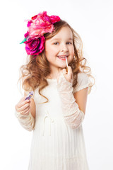 Little girl applying lipstick