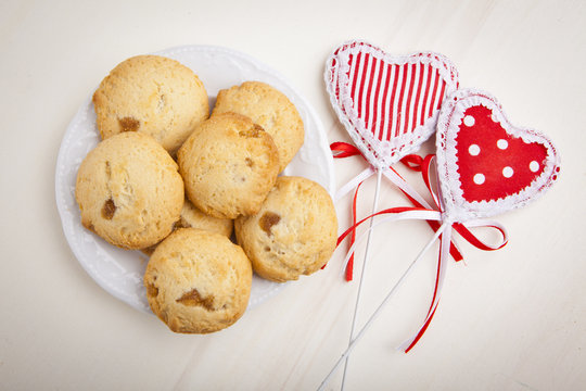 delicious apple biscuits on wooden table with heart decorations
