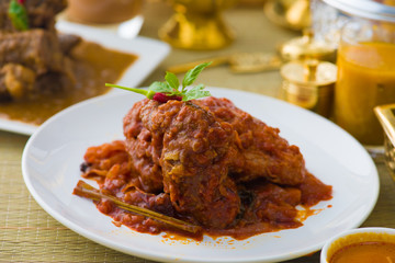 curry chicken cooked in indian style with spicy sauce and chilli