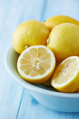 Lemons in a bowl; whole and halved