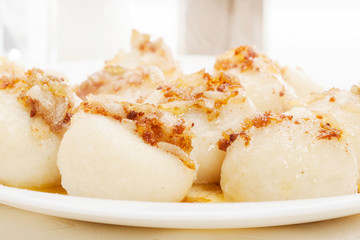Meat stuffed dumplings with fried onion