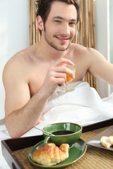 Man having breakfast in bed