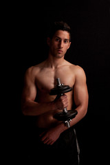 portret of a man with dumbbell in hand