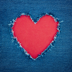 Naklejka na ściany i meble Blue denim background with red heart