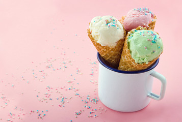 Ice cream cones with sprinkles on pink background
