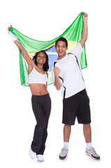 Young Couple Holding Brazil Flag