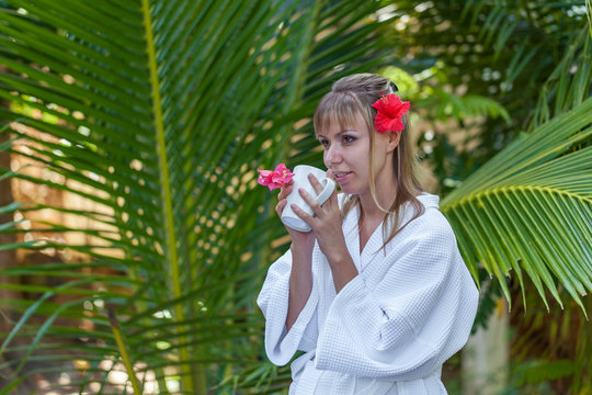 girl with a cup of morning coffee in the garden
