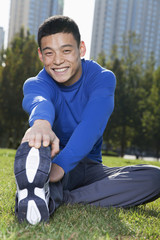 Young Athletic Man Stretching in Beijing Park- Vertical