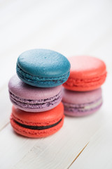 Stacked macaroons of different colours, vertical shot