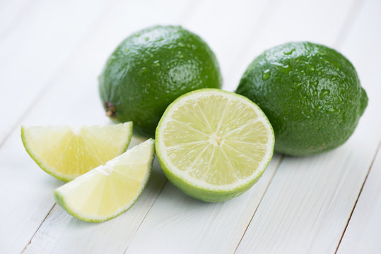 Ripe limes on wooden boards, horizontal shot