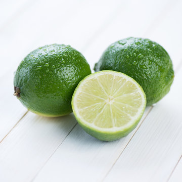 Ripe limes on wooden boards, close-up