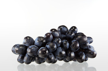 Fresh blue grape fruit on white background