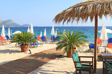 Beach bar by the sea with straw umbrella