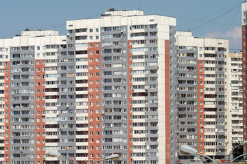 Many new modern city buildings over blue clear cloudless sky