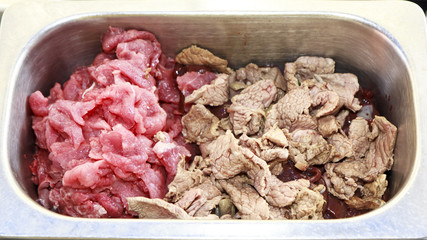 Fresh meat and meat boiled in a pot.