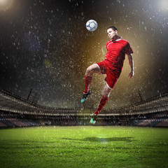 Obraz na płótnie Canvas football player striking the ball