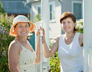 women near fence wicket