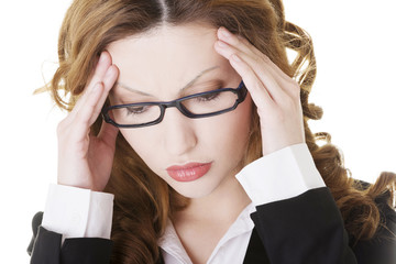 Businesswoman with a headache holding head