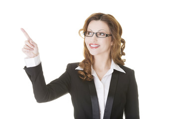 Happy success businesswoman pointing