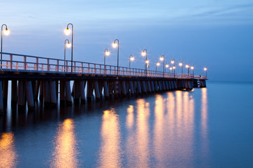 Fototapeta premium Sunrise on the pier at the seaside, Gdynia Orlowo, Poland.