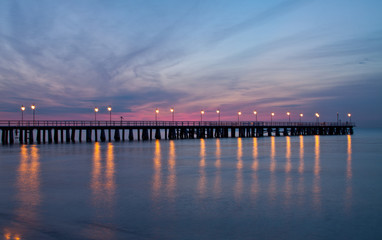 Obraz na płótnie Canvas Sunrise on the pier at the seaside, Gdynia Orlowo, Poland.