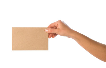 Hand with blank kraft paper envelope isolated on white.