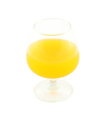 Orange juice in brandy glass on white background.