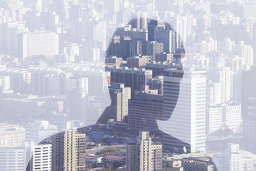 Double exposure of man over cityscape, rear view