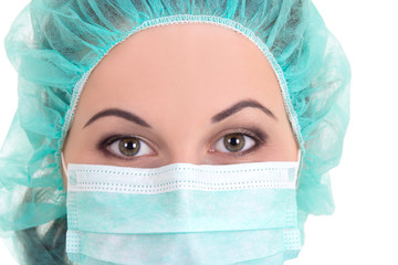 close up portrait of female doctor in blue mask and cap over whi