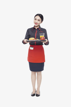 Young Waitress Carrying Tray With Food, Studio Shot