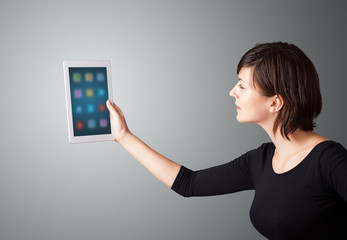 woman holding modern tablet with colorful icons