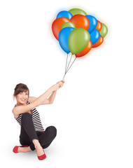 Young woman holding colorful balloons