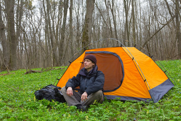 tourist sit near a tent