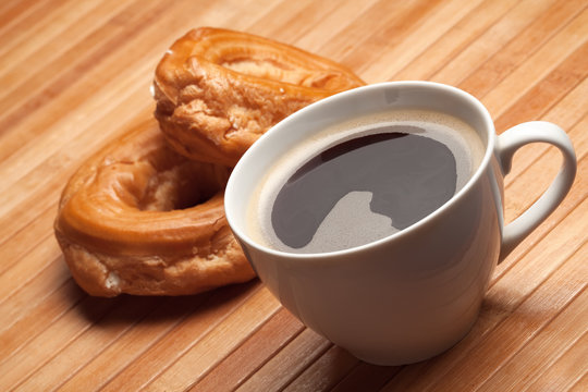 cup of coffee and sweet rings