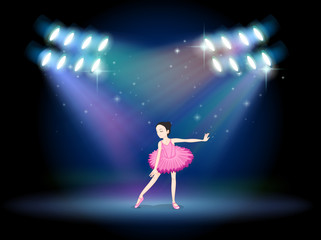 Fototapeta na wymiar A young girl dancing ballet with spotlights
