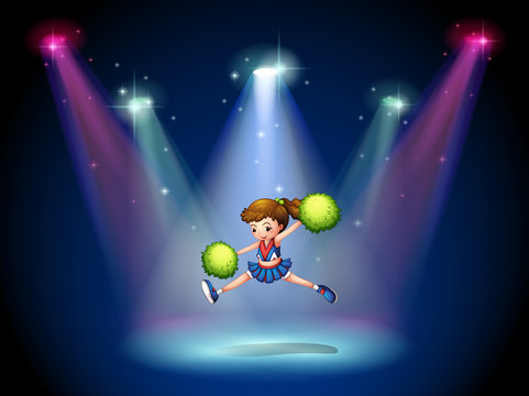 A cheerleader jumping on the stage with spotlights