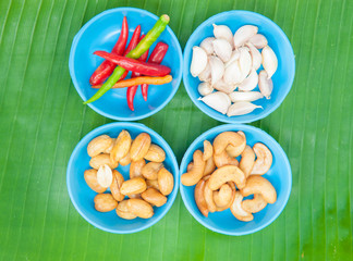 Red chilli garlic and bean on green leaf