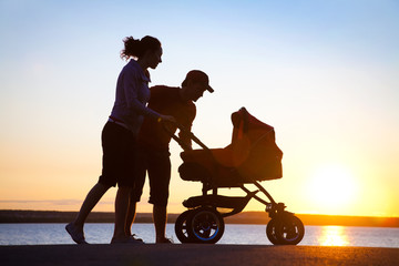 happy family walking on sunset