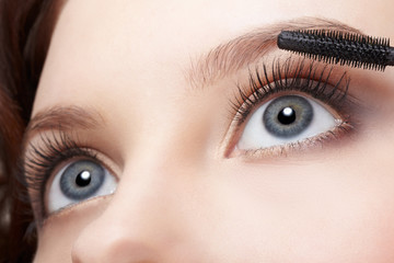 beautiful woman applying mascara