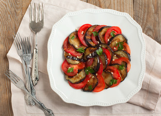 Grilled eggplants with fresh tomatoes and garlic